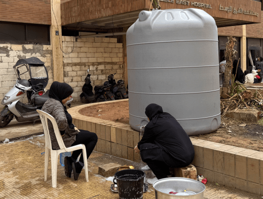 displaced women in Lebanon washing dishes