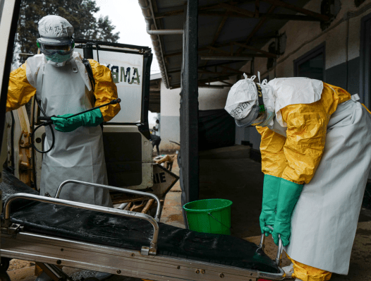 Two hygienists disinfects an ambulance which carried a suspected Ebola case in the Butembo Ebola isolation center.
